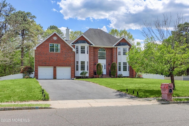 1041 Aumack Rd, Jackson, NJ 08527 - colonial-style house featuring brick siding, asphalt driveway, a chimney, and a garage