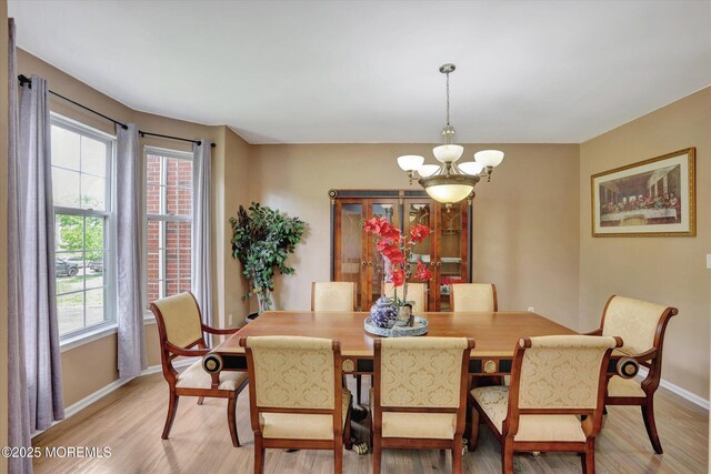 1041 Aumack Rd, Jackson, NJ 08527 - dining room featuring a chandelier, baseboards, and light wood finished floors