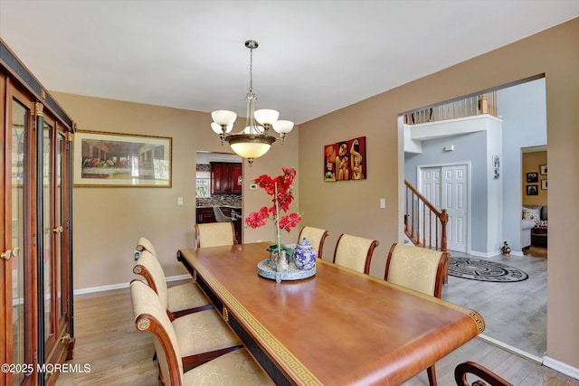 1041 Aumack Rd, Jackson, NJ 08527 - dining space featuring light wood-type flooring, a chandelier, and baseboards