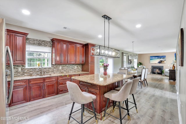 1041 Aumack Rd, Jackson, NJ 08527 - kitchen featuring a sink, dark brown cabinets, light wood-type flooring, decorative backsplash, and recessed lighting