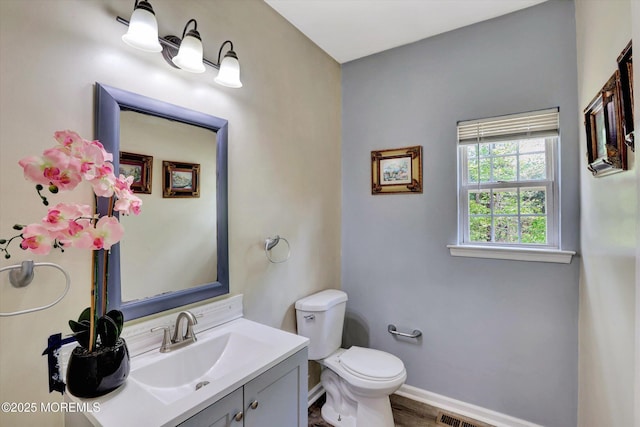 1041 Aumack Rd, Jackson, NJ 08527 - bathroom with baseboards, toilet, vanity, and wood finished floors