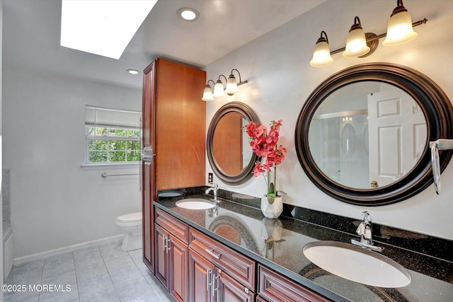 1041 Aumack Rd, Jackson, NJ 08527 - bathroom featuring a skylight, double vanity, toilet, recessed lighting, and tile patterned floors
