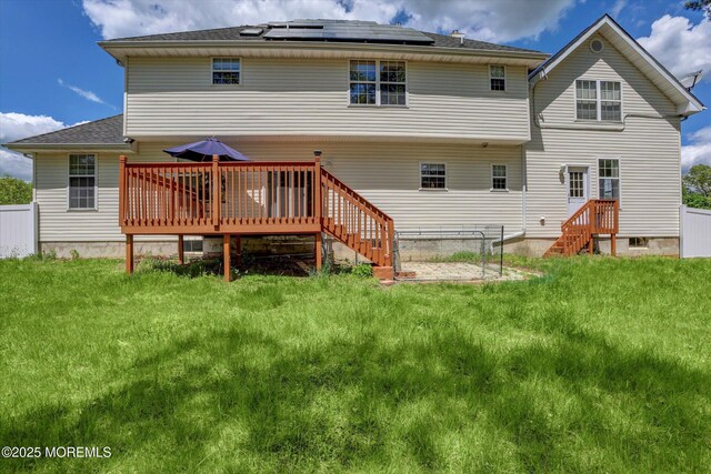 1041 Aumack Rd, Jackson, NJ 08527 - back of property featuring roof mounted solar panels, a deck, and a yard