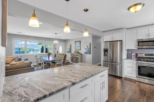 37 Bimini Rd, Brick, NJ 08723 - kitchen with appliances with stainless steel finishes, dark wood-type flooring, light stone countertops, backsplash, and decorative light fixtures
