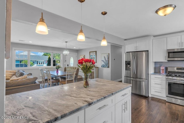 37 Bimini Rd, Brick, NJ 08723 - kitchen with appliances with stainless steel finishes, dark wood-type flooring, light stone counters, open floor plan, and white cabinetry