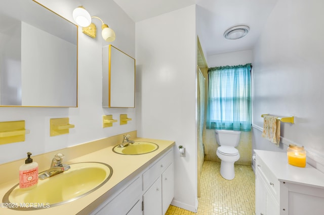 bathroom featuring toilet, tile patterned floors, double vanity, and a shower