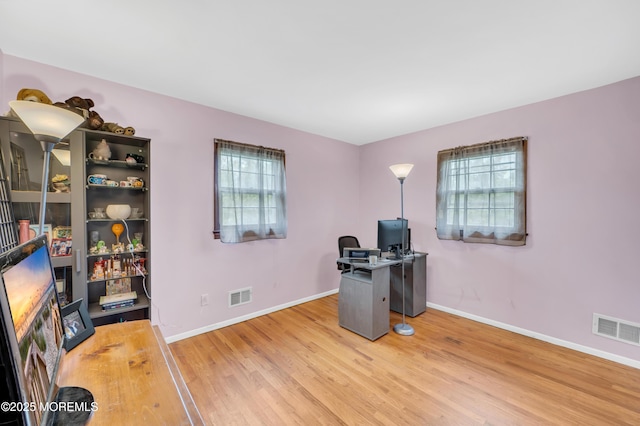 unfurnished office with wood finished floors and baseboards