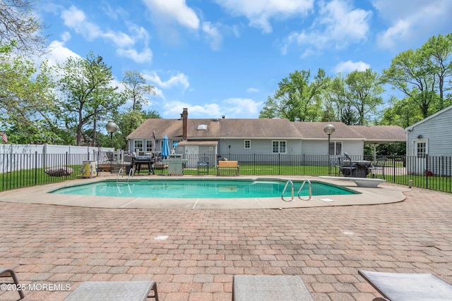 view of pool featuring fence, a patio, and a diving board