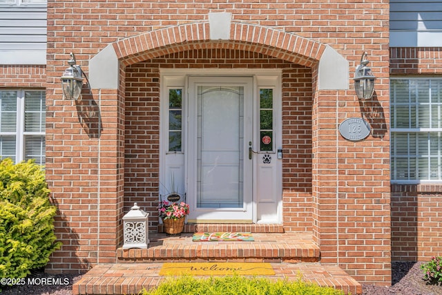 entrance to property with brick siding