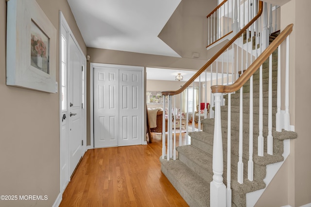 entryway with wood finished floors and stairs
