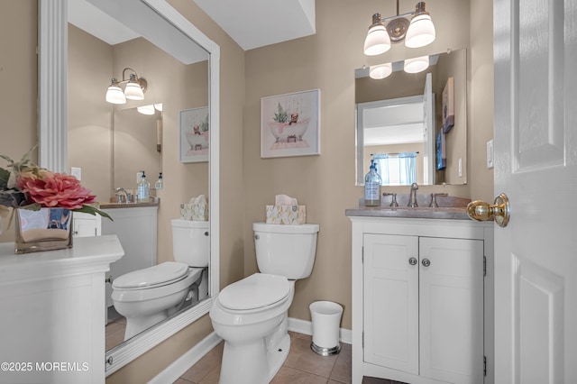 bathroom featuring tile patterned floors, toilet, vanity, and baseboards