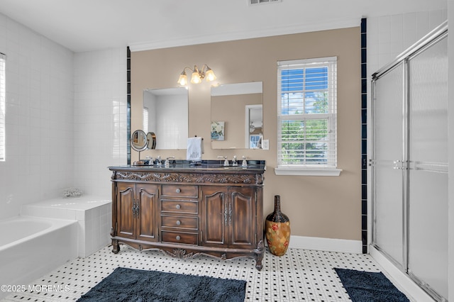 full bathroom featuring a garden tub, a shower stall, double vanity, baseboards, and tile patterned floors