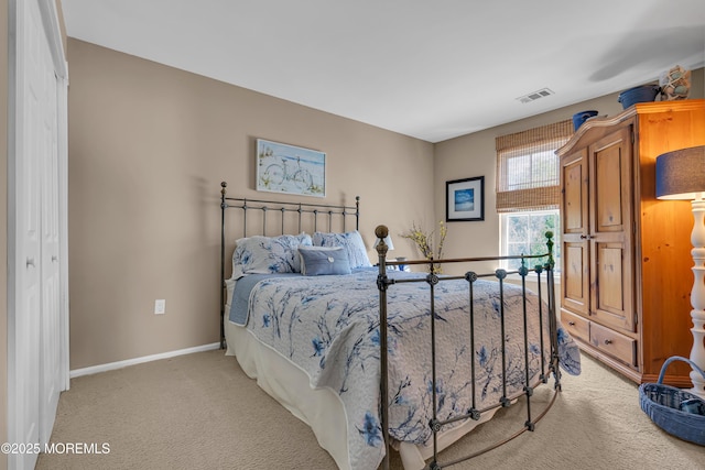 bedroom featuring light carpet and baseboards