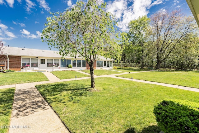1154A Argyll Cir, Lakewood, NJ 08701 - ranch-style house with brick siding, a front lawn, and a sunroom