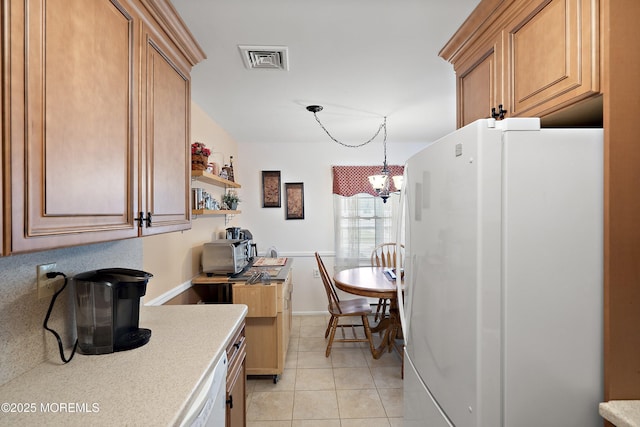 1154A Argyll Cir, Lakewood, NJ 08701 - kitchen with white appliances, light countertops, light tile patterned floors, a chandelier, and hanging light fixtures