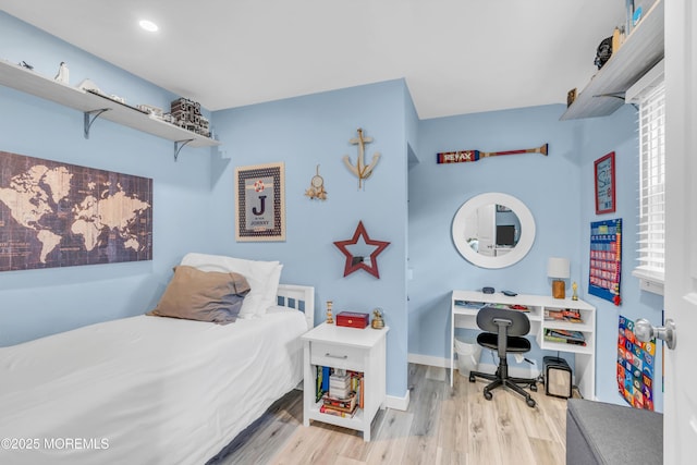 bedroom with wood finished floors, an office area, baseboards, and recessed lighting