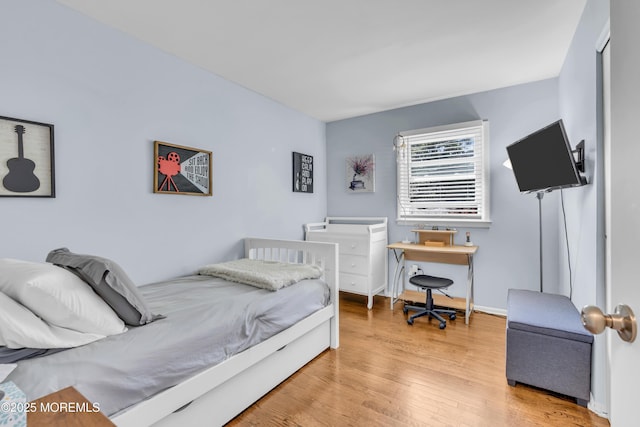 bedroom featuring light wood-type flooring and baseboards