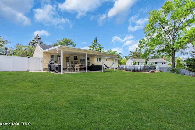 back of property with a patio, a gate, and outdoor lounge area