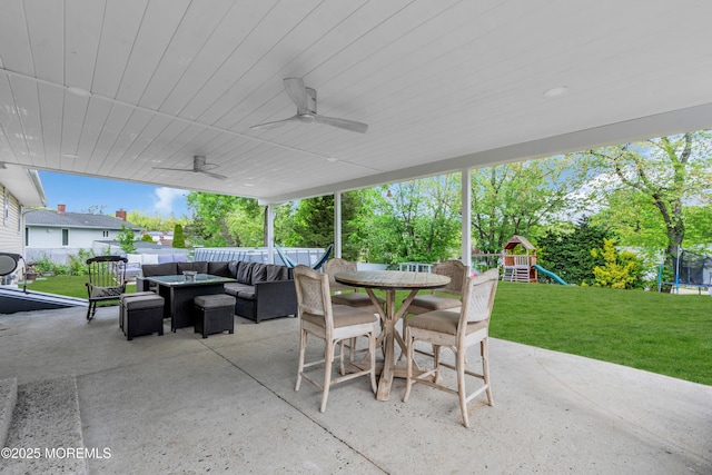 view of patio / terrace featuring a trampoline, outdoor lounge area, a playground, outdoor dining area, and ceiling fan