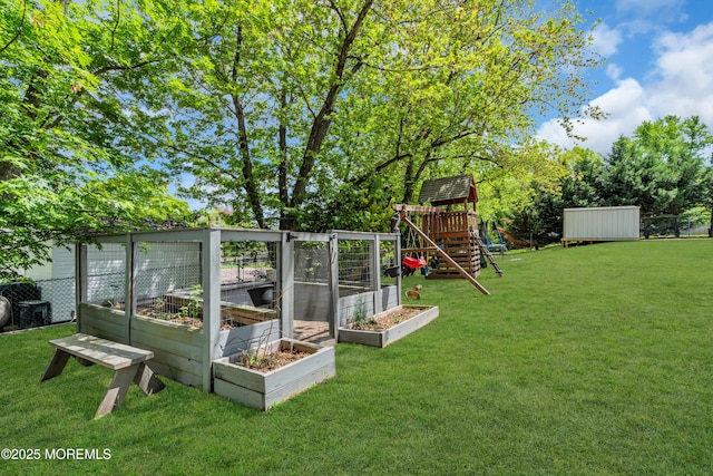 view of grassy yard with a playground and a garden