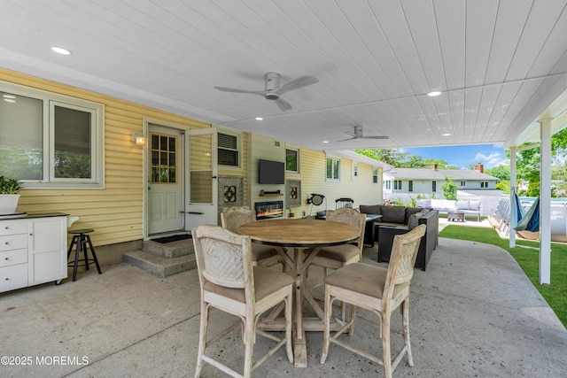 view of patio / terrace featuring outdoor lounge area, outdoor dining area, entry steps, and ceiling fan