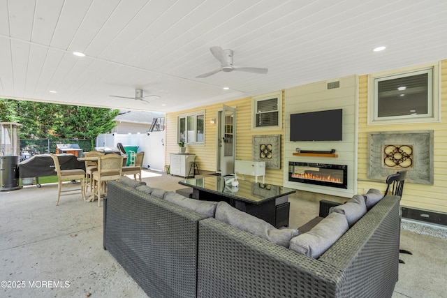 view of patio / terrace featuring outdoor lounge area, fence, outdoor dining space, and a ceiling fan