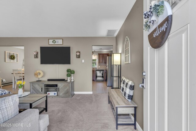 2465 Woodland Rd, Manchester, NJ 08759 - living area with a baseboard radiator, light colored carpet, and baseboards