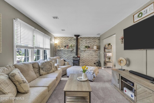 2465 Woodland Rd, Manchester, NJ 08759 - living area featuring a wood stove, brick wall, and carpet floors
