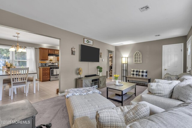 2465 Woodland Rd, Manchester, NJ 08759 - living area featuring light tile patterned floors and a chandelier