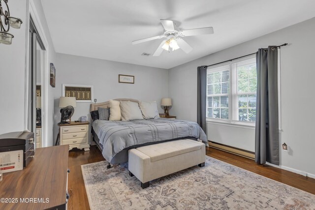 2465 Woodland Rd, Manchester, NJ 08759 - bedroom with dark wood-style floors, baseboard heating, and ceiling fan