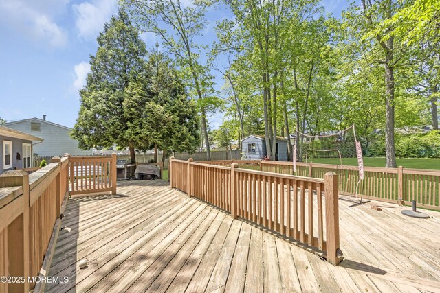 2465 Woodland Rd, Manchester, NJ 08759 - wooden terrace featuring a storage shed, an outbuilding, and fence
