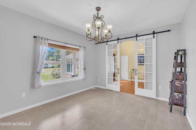 1042 Maxim Southard Rd, Howell, NJ 07731 - unfurnished room featuring a barn door, french doors, a chandelier, and baseboards