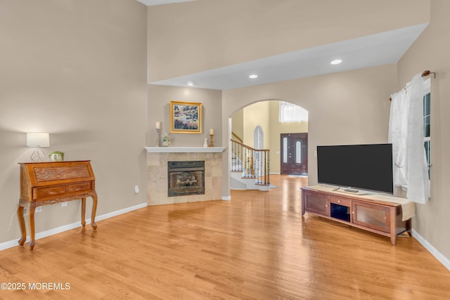 1042 Maxim Southard Rd, Howell, NJ 07731 - living room with arched walkways, wood finished floors, a fireplace, baseboards, and recessed lighting