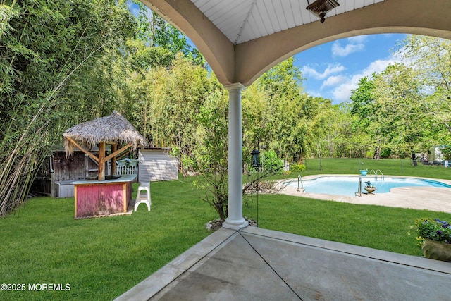 1042 Maxim Southard Rd, Howell, NJ 07731 - view of patio / terrace with an outdoor pool, an outbuilding, a gazebo, a storage unit, and view of wooded area