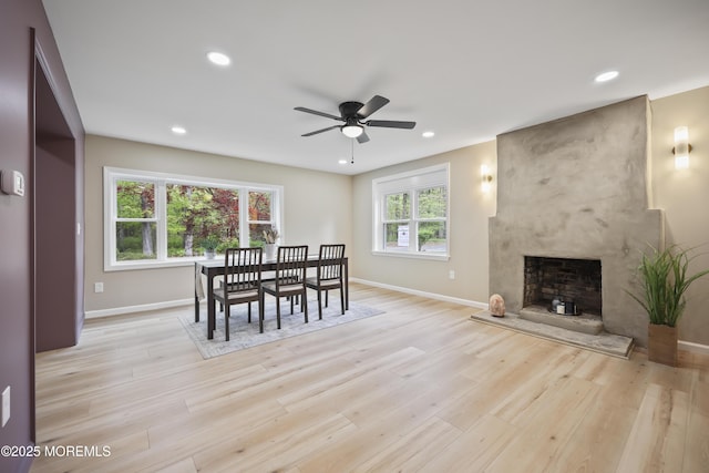 dining room with baseboards, ceiling fan, light wood-style flooring, and recessed lighting