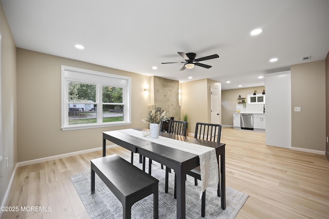 dining area featuring light wood-style flooring, a ceiling fan, recessed lighting, and baseboards