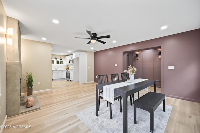 dining space featuring ceiling fan, light wood finished floors, baseboards, and recessed lighting