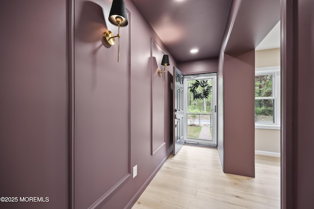 doorway to outside featuring light wood finished floors, recessed lighting, and baseboards