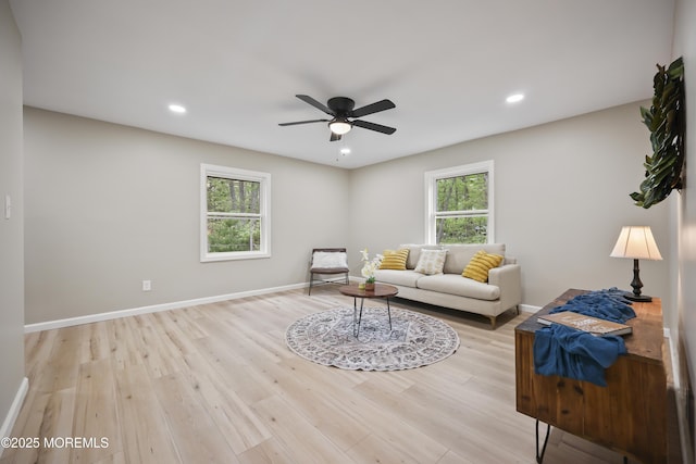 living room with light wood-type flooring, ceiling fan, recessed lighting, and baseboards