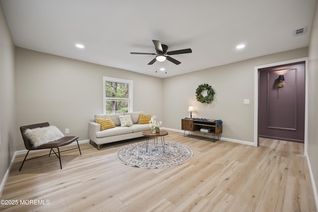 living room featuring a ceiling fan, light wood-style flooring, baseboards, and recessed lighting