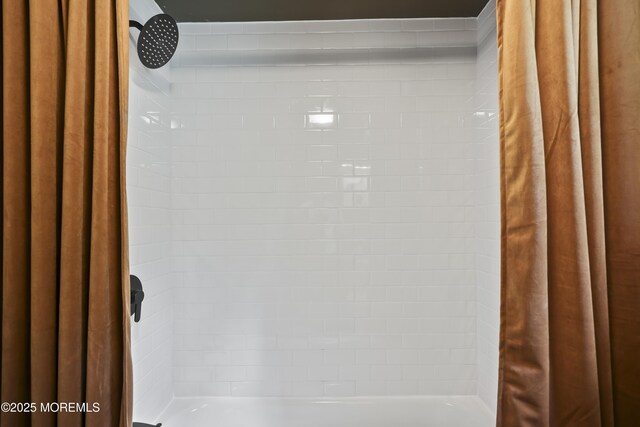 bathroom view of a shower with shower curtain
