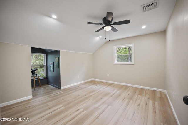 additional living space featuring baseboards, a ceiling fan, light wood-type flooring, lofted ceiling, and recessed lighting