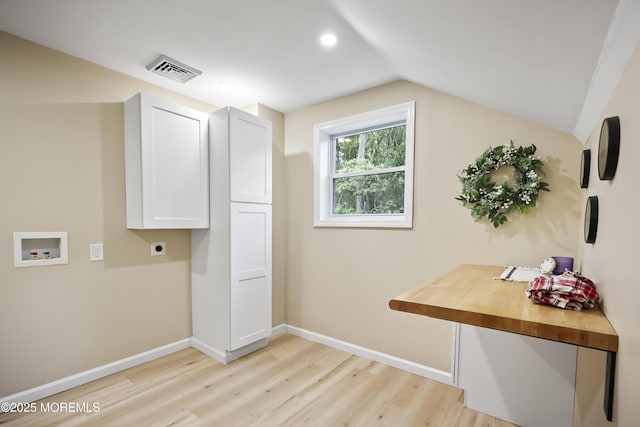 laundry room with hookup for an electric dryer, washer hookup, cabinet space, light wood-type flooring, and baseboards
