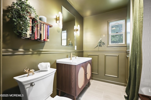 bathroom featuring tile patterned flooring, vanity, toilet, and a shower with curtain