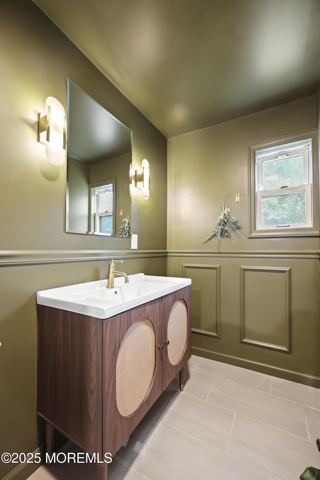 bathroom with plenty of natural light, vanity, and tile patterned flooring