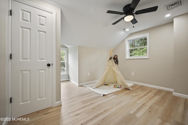 rec room with baseboards, healthy amount of natural light, light wood-style floors, lofted ceiling, and a ceiling fan