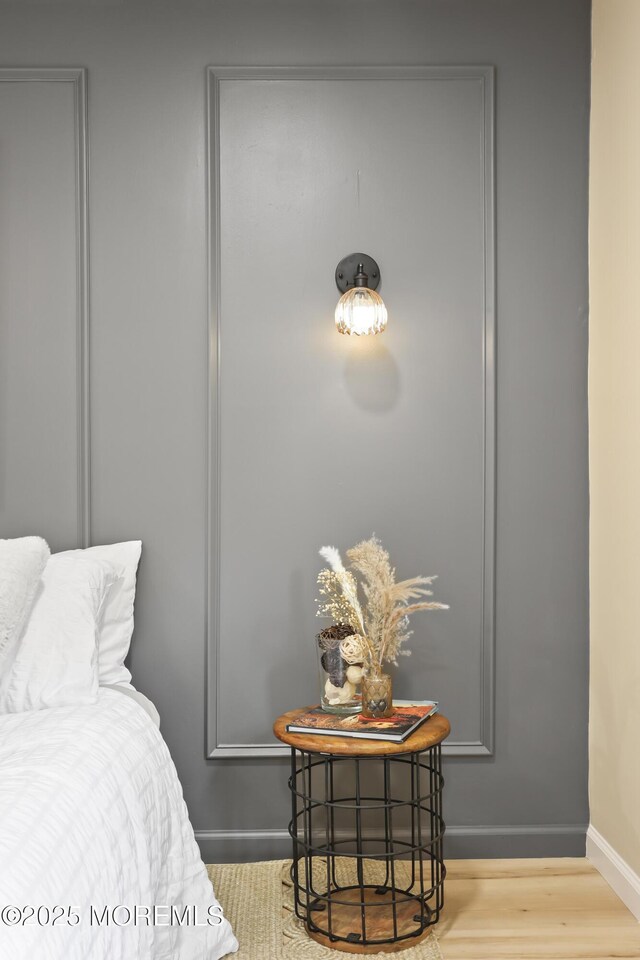 bedroom featuring baseboards and wood finished floors