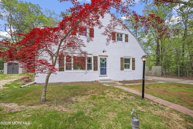 view of front of house featuring entry steps, a storage shed, and an outbuilding