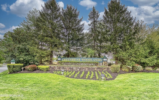 community / neighborhood sign with a yard