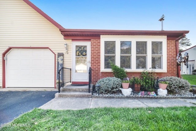 17B Drake St, Whiting, NJ 08759 - view of front of home with an attached garage, asphalt driveway, and brick siding